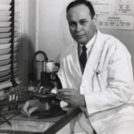Portrait of Charles Drew in a laboratory wearing a lab coat.